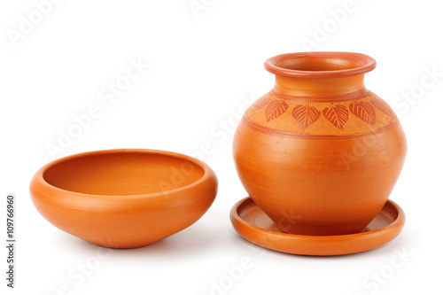 Clay pot and different tableware. photo