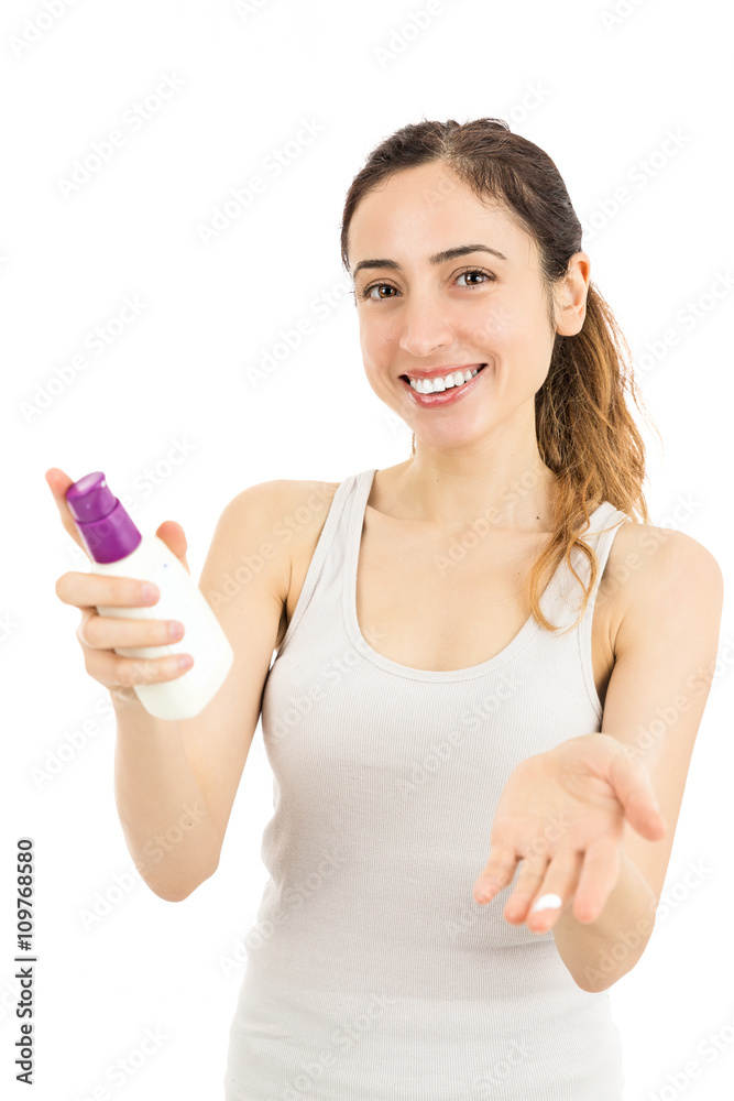Woman showing moisturizer on her fingers Woman showing moisturizer on her fingers