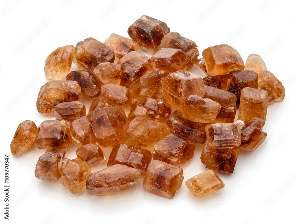 Brown caramelized lump cane sugar cube isolated on white backgro Brown caramelized lump cane sugar cube isolated on white backgro