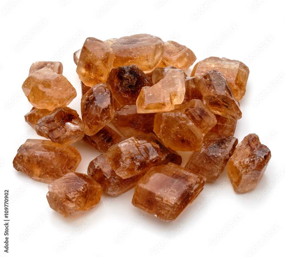 Brown caramelized lump cane sugar cube isolated on white backgro