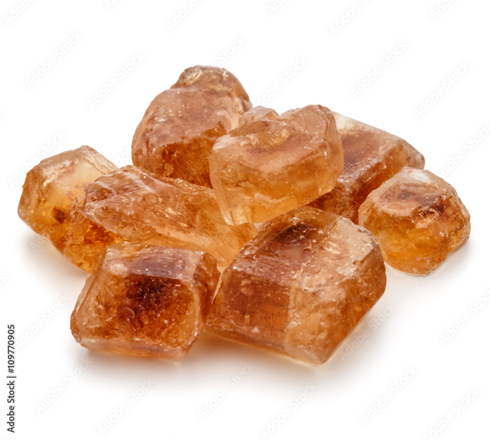 Brown caramelized lump cane sugar cube isolated on white backgro Brown caramelized lump cane sugar cube isolated on white backgro