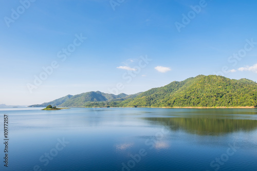 Blue sky reflection and mountain on dam at kanchanaburi © Mumemories