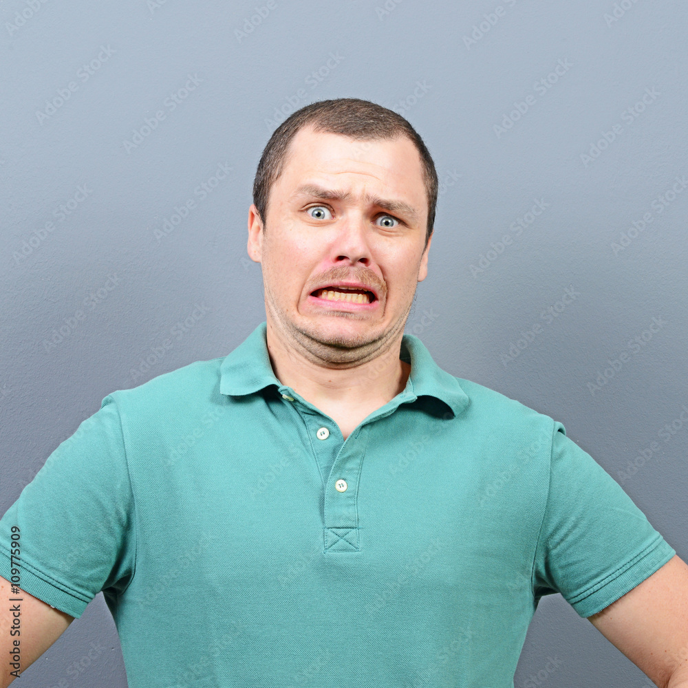 Obraz premium Disgusted man against gray background