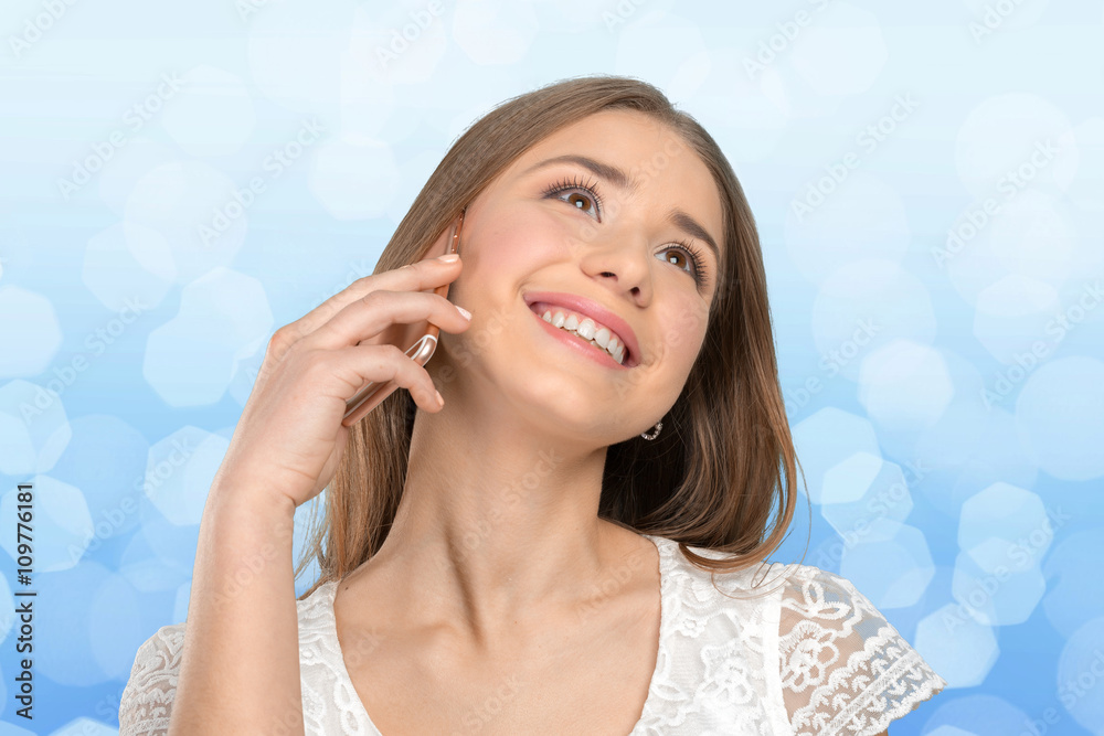 Fototapeta premium Young elegant woman talking on mobile phone