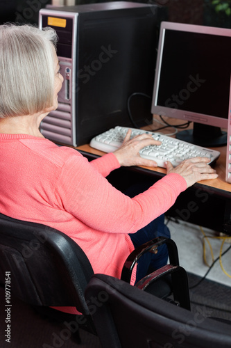 Senior Woman Using Computer At Desk In Classroom © Tyler Olson