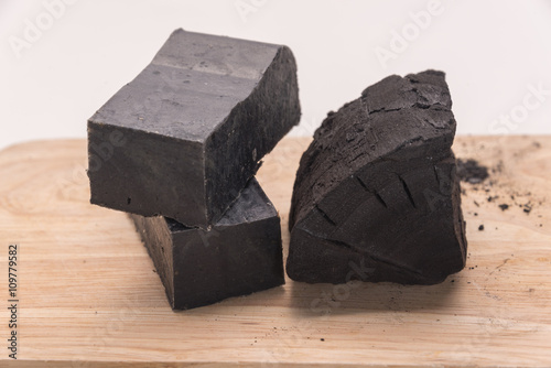 carbon soap  and a pile of coal on wooden tray