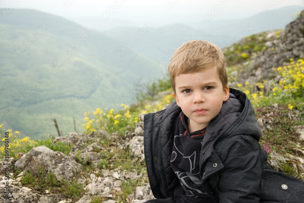 small mountain climber sits on top of the mountain