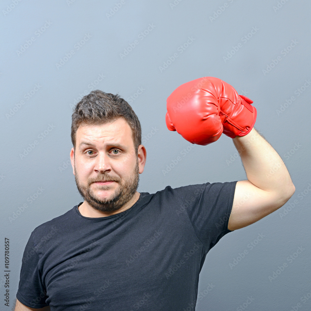 Portrait of chubby boxer posing with boxing gloves as a champion Portrait of chubby boxer posing with boxing gloves as a champion
