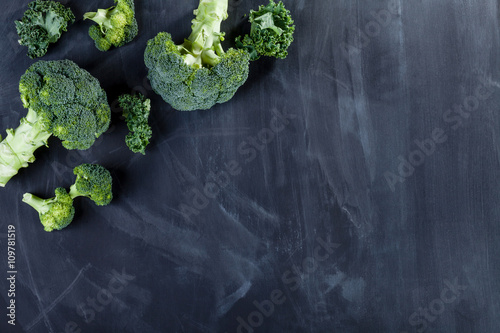 Curly kale and broccoli on blackboard