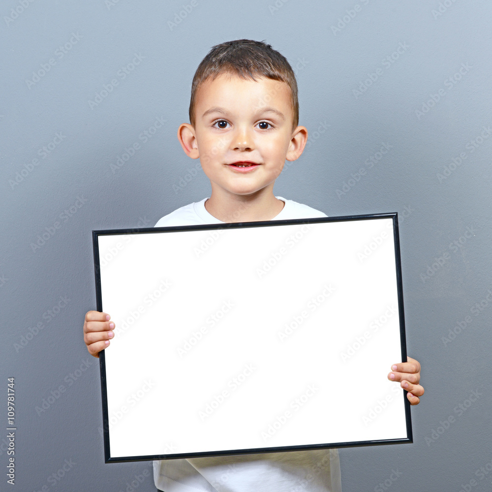 Cute little boy kid holding blank board with space for some text Cute little boy kid holding blank board with space for some text