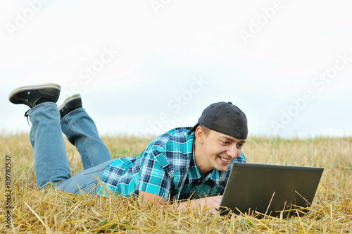 a business man in a countryside with a laptop