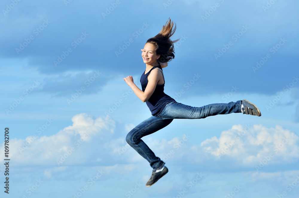 beautiful girl in gymnastic jump against blue sky beautiful girl in gymnastic jump against blue sky