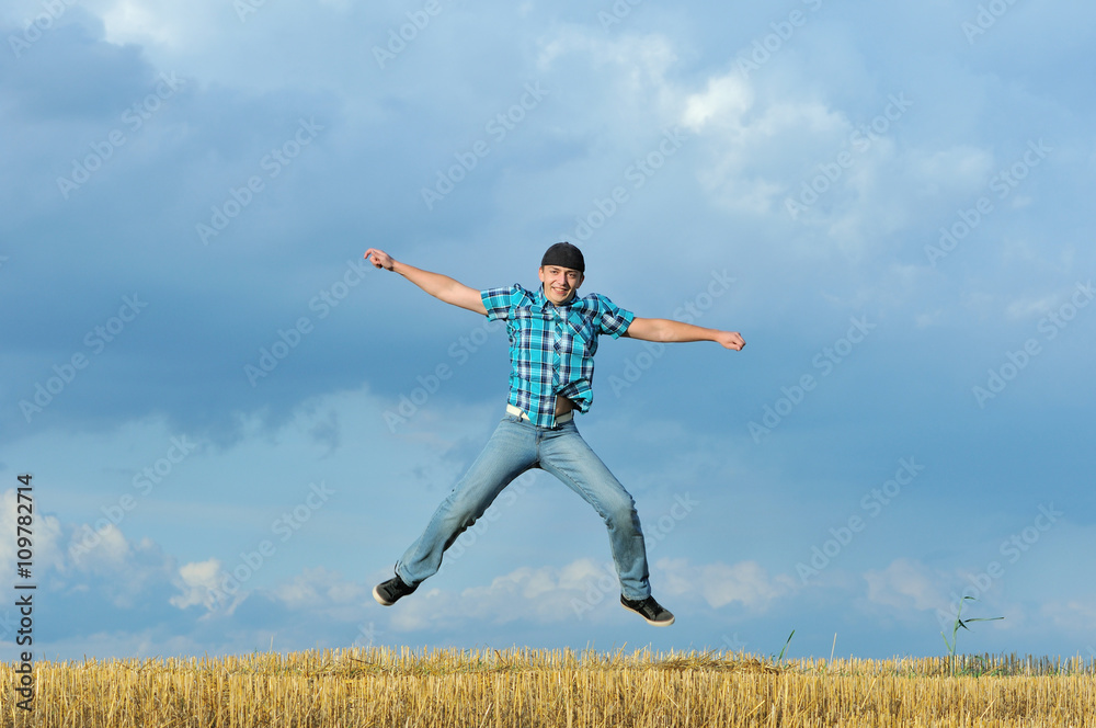 Boy jumping, running against blue sky Boy jumping, running against blue sky