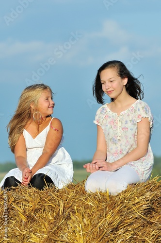 Two happy young girl friends enjoying the nature