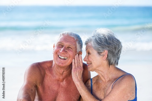 Cute mature couple sitting on the beach © WavebreakmediaMicro