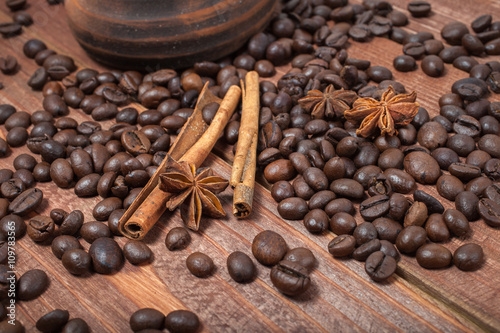 Coffee beans and spices on a wooden table