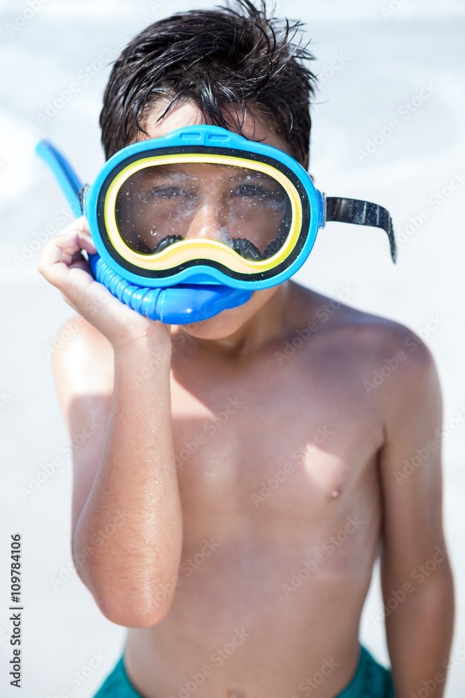 Boy with diving goggles standing at beach Boy with diving goggles standing at beach
