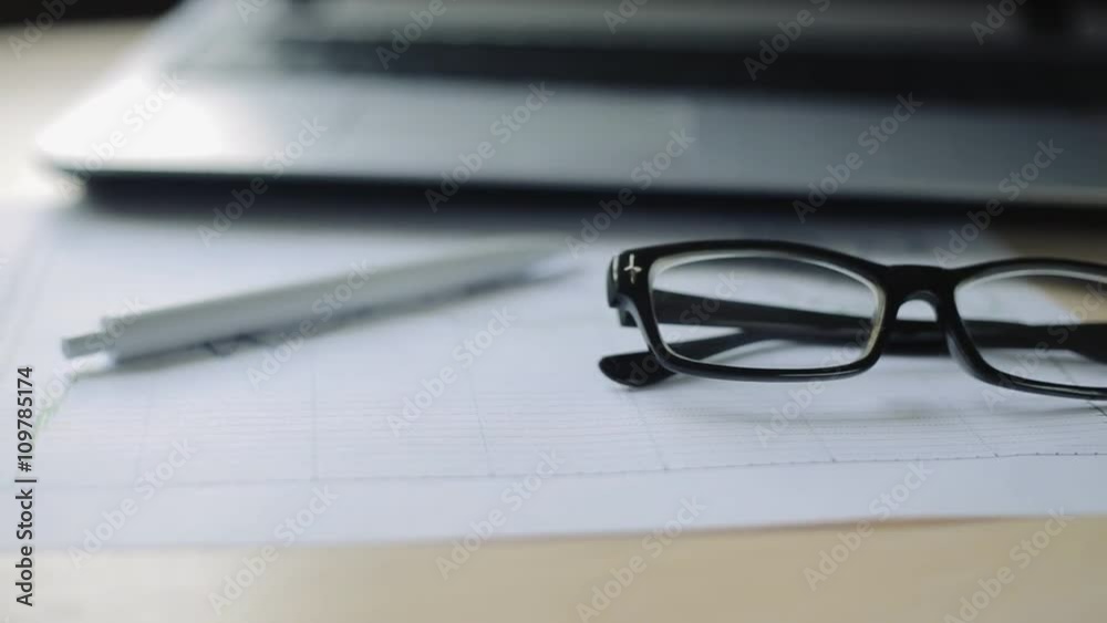 eyeglasses and pen lie on business charts. close up eyeglasses and pen lie on business charts. close up