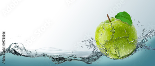 Fotografija Postcard, ripe green apple fruit in a spray of water.