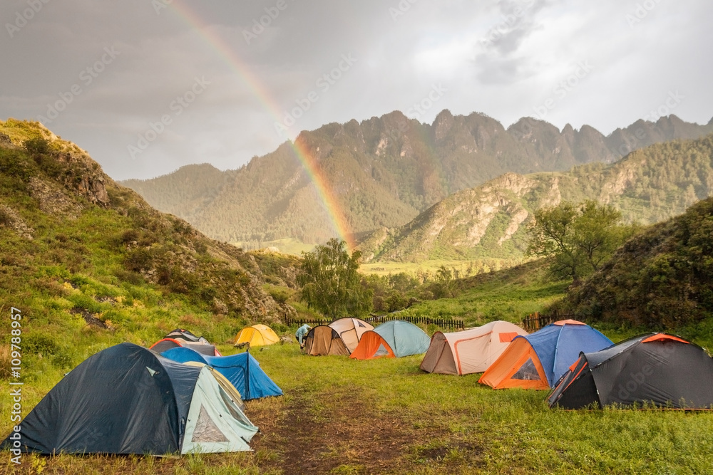 Double rainbow at campsite in mountains