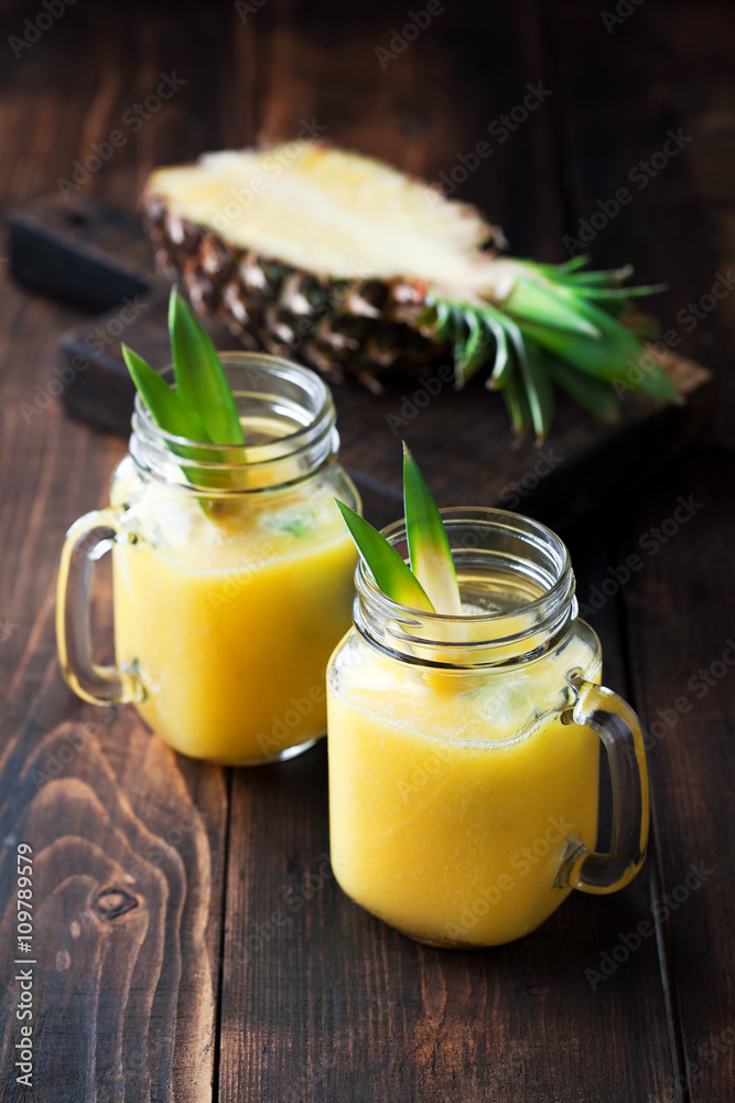 Healthy pineapple smoothie in mason jars, selective focus Healthy pineapple smoothie in mason jars, selective focus
