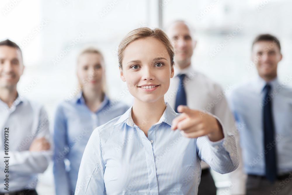 smiling businesswoman pointing finger on you smiling businesswoman pointing finger on you