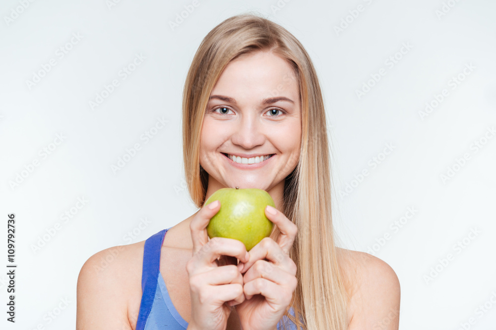 Happy sports woman holding apple Happy sports woman holding apple