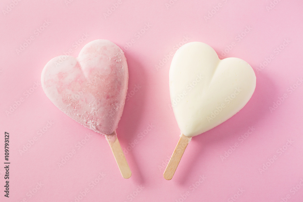 Two pink and white popsicles