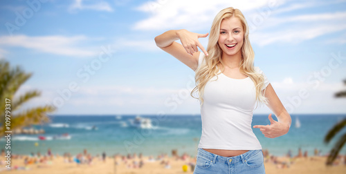 happy young woman or teenage girl in white t-shirt