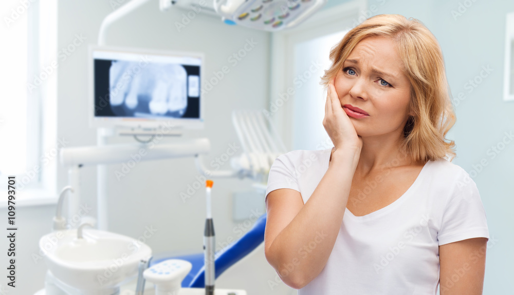 unhappy woman suffering toothache at dental office unhappy woman suffering toothache at dental office