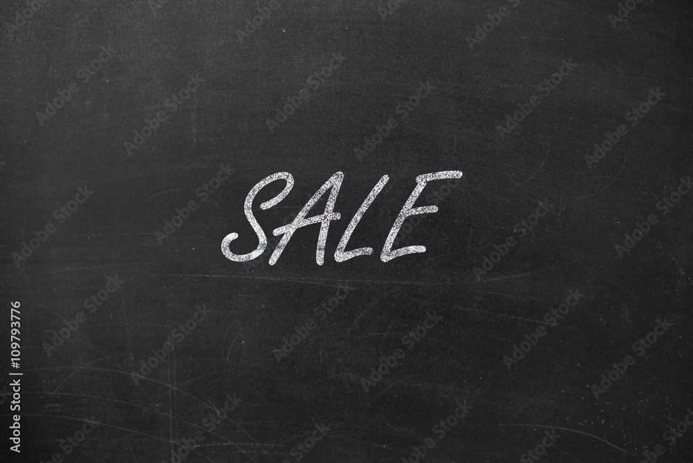 Fototapeta premium text SALE. Written in chalk on a blackboard.