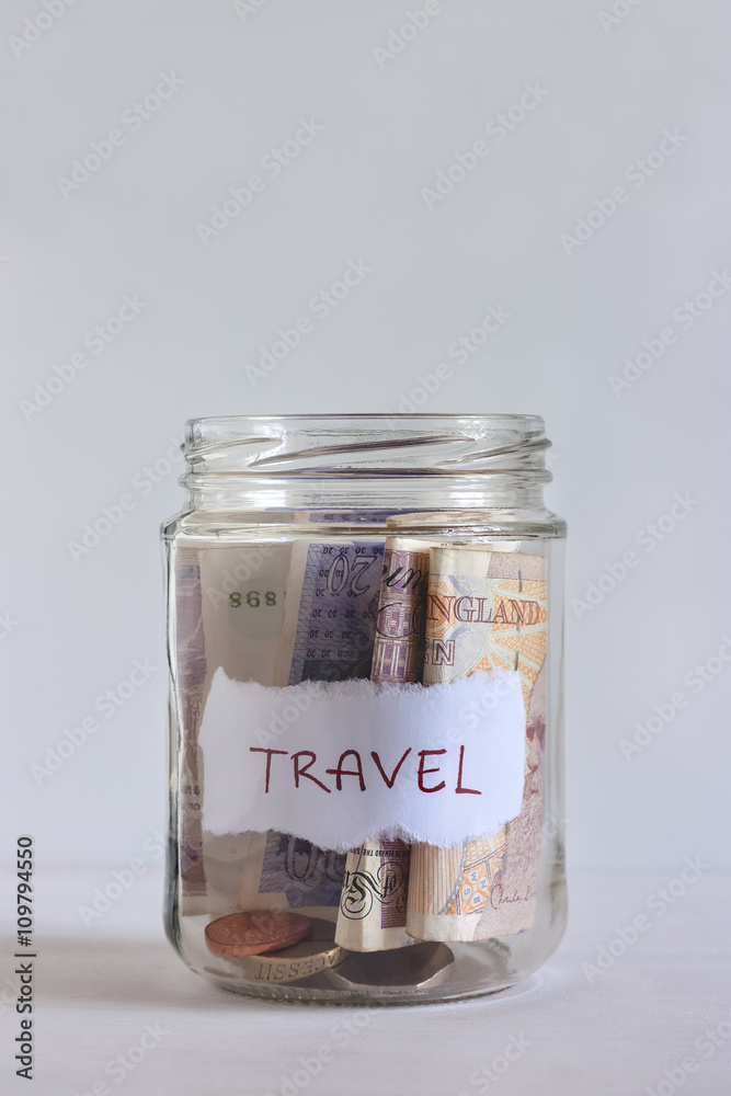 A jar filled with British coins and banknotes A jar filled with British coins and banknotes