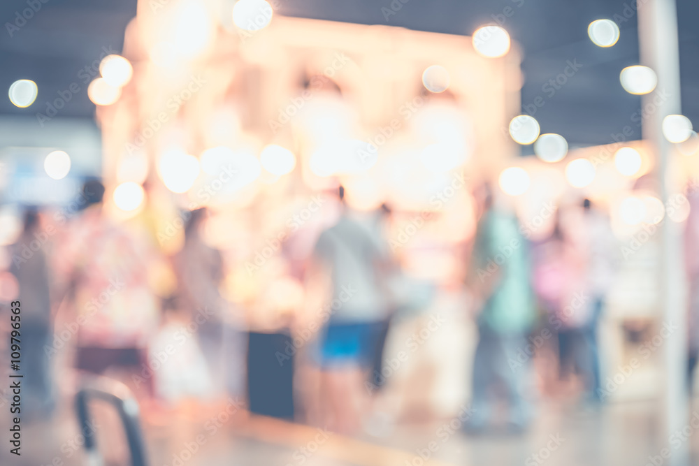 Blurred background,crowd of people in expo fair with bokeh light Blurred background,crowd of people in expo fair with bokeh light