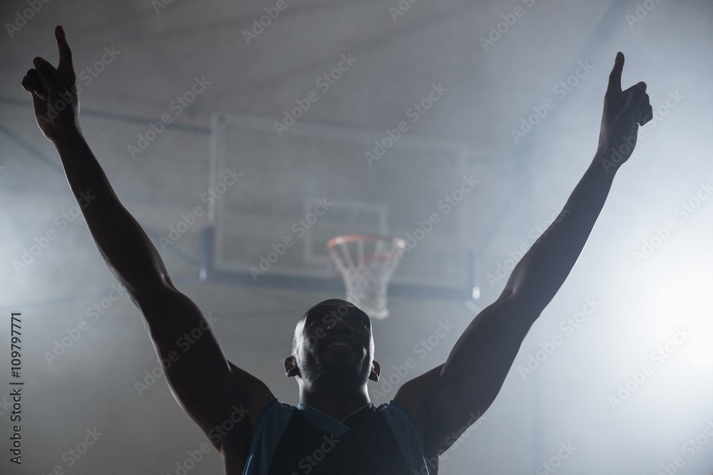 Fototapeta premium Rear view of a basketball player with his arms in the air