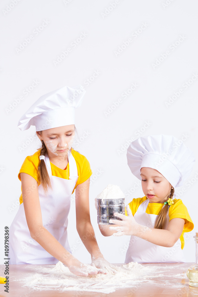 Children make the dough in the kitchen, roll a rolling pin Children make the dough in the kitchen, roll a rolling pin