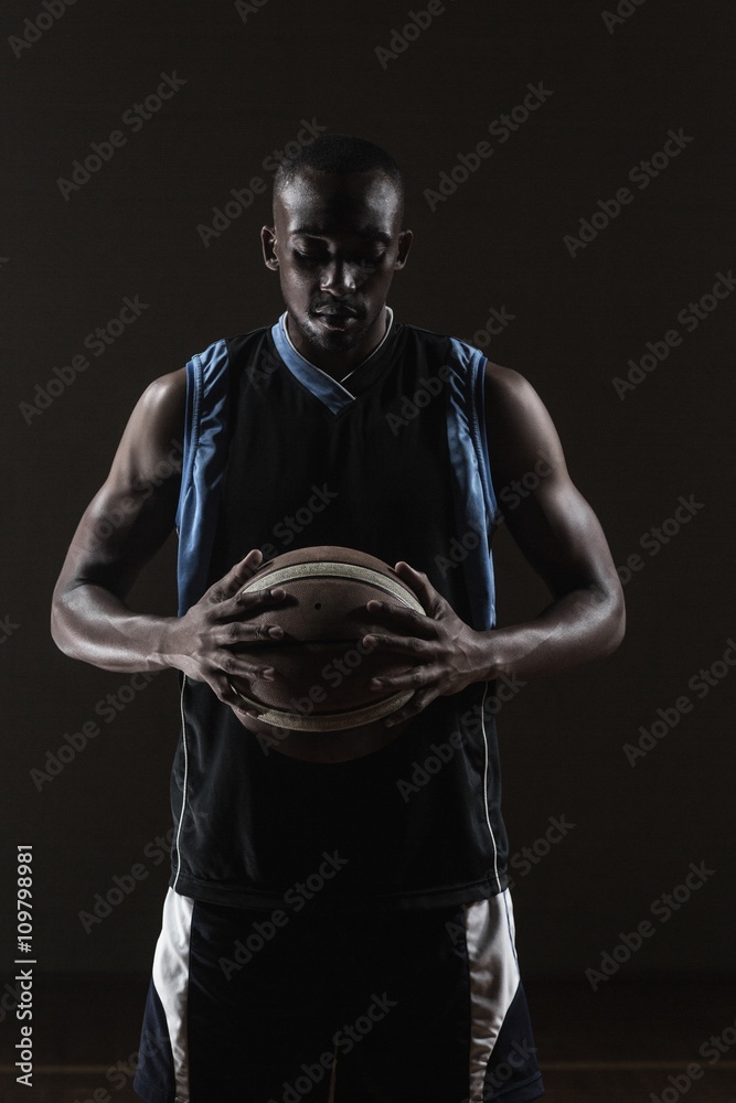 Fototapeta premium Portrait of basketball player holding a ball