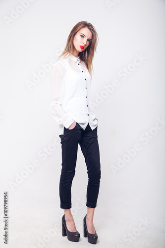 Contemporary Clothing Design. Modish Woman in White Blouse and Pants. Fashion