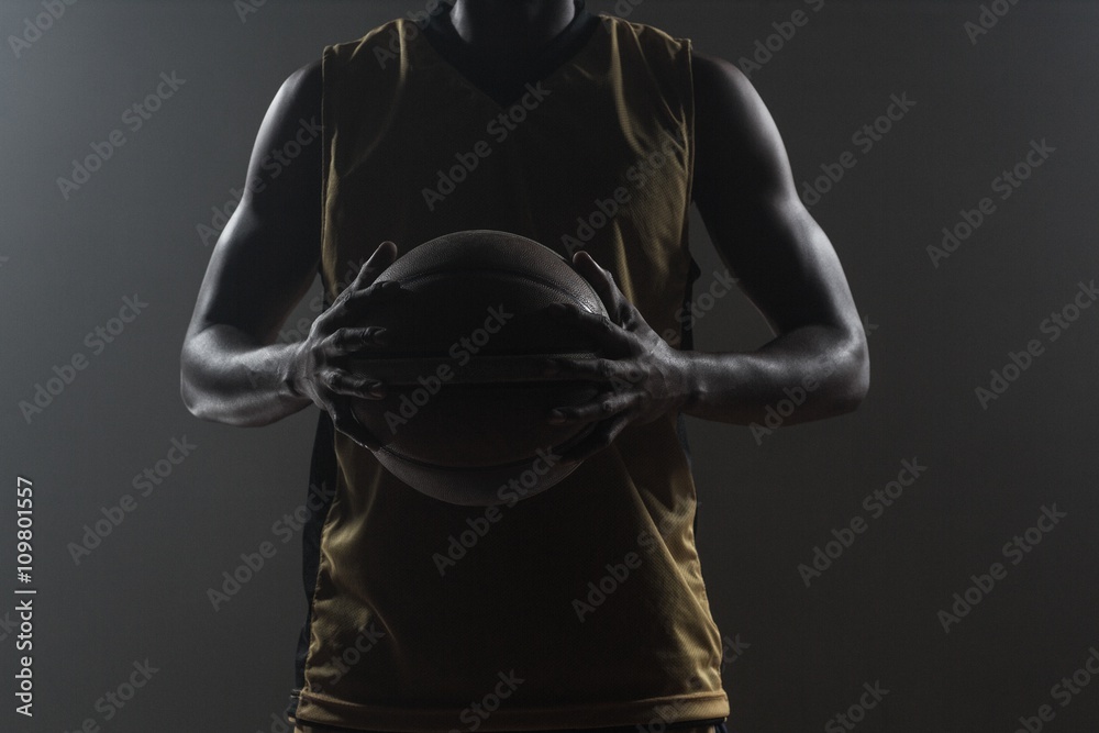 Fototapeta premium Close up on basketball player holding a ball