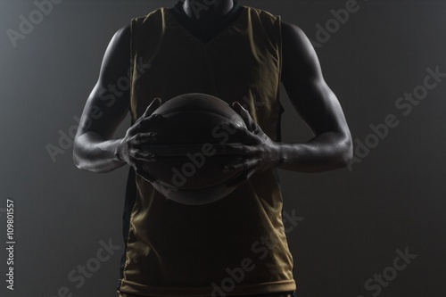 Close up on basketball player holding a ball © WavebreakmediaMicro