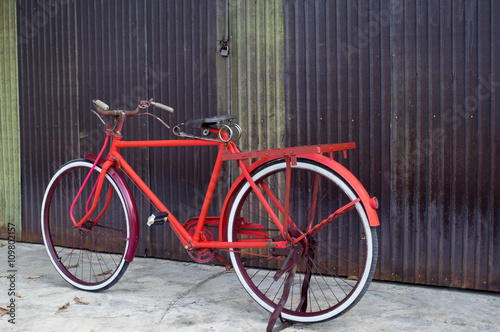 classic bicycle at rusty zinc door.