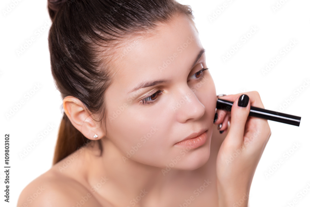 Young woman applying make up face nude Young woman applying make up face nude