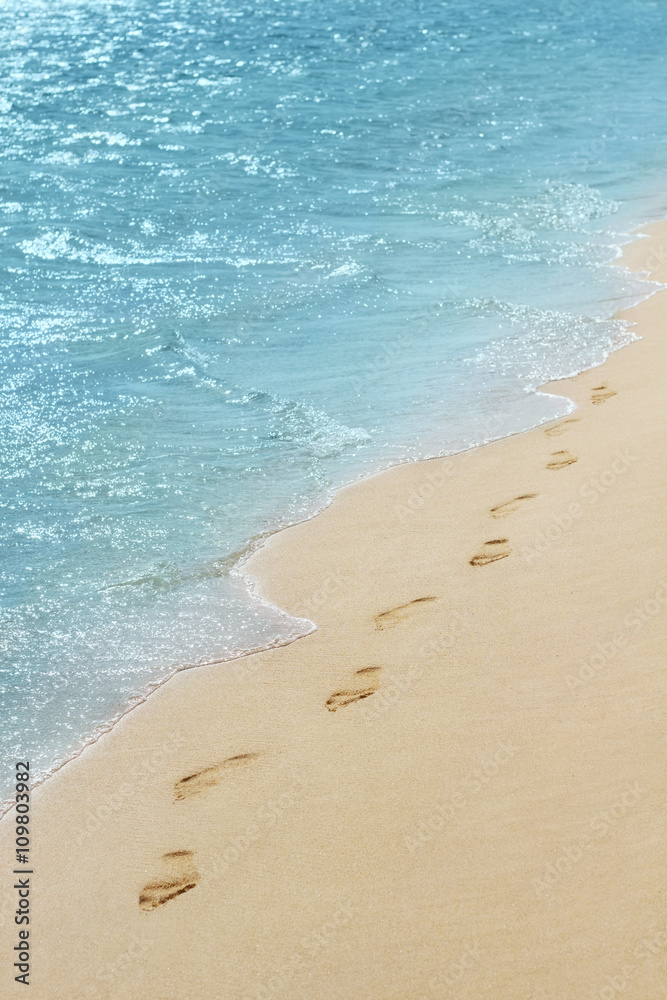 Foot prints on a sandy beach with selective focus Foot prints on a sandy beach with selective focus