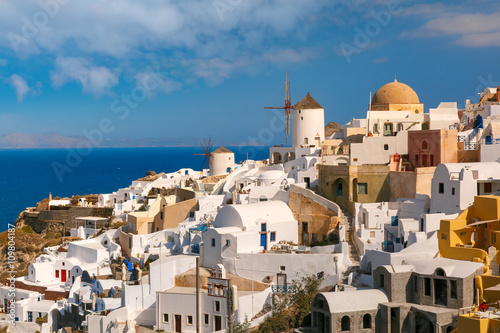 Picturesque view of windmills and white houses in Oia or Ia on the island Santorini, Greece
