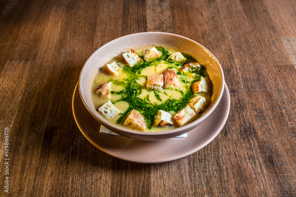 Creamy pea soup with croutons on a wooden table. Selective focus Creamy pea soup with croutons on a wooden table. Selective focus