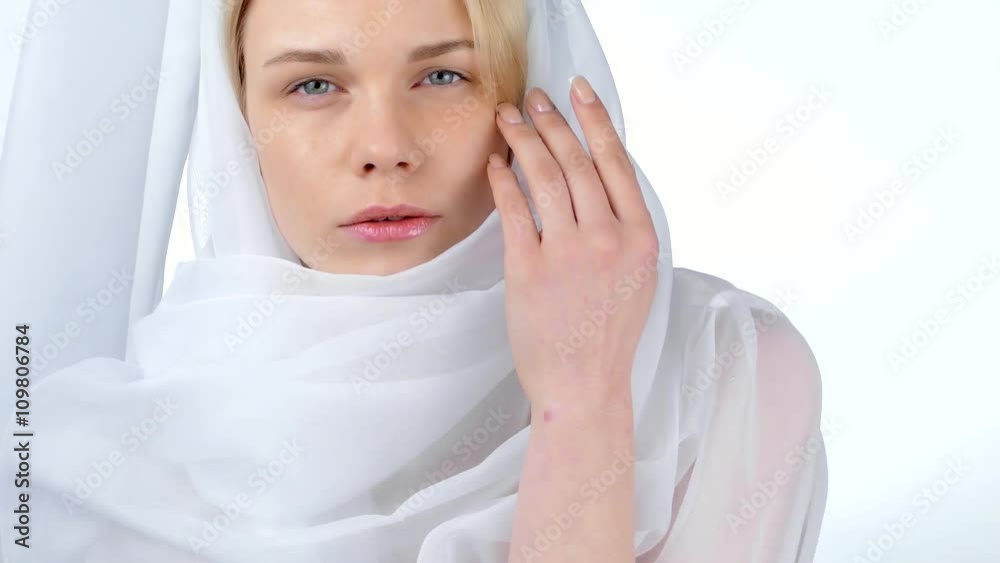 Portrait of the blonde in white clothes posing in the studio on a white background Portrait of the blonde in white clothes posing in the studio on a white background