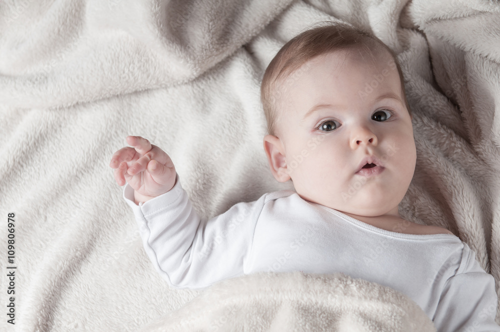 Beautiful little girl lying on her back and posing Stock Photo | Adobe ...