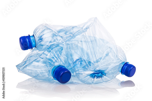 Mineral water bottles crushed and crumpled against white background