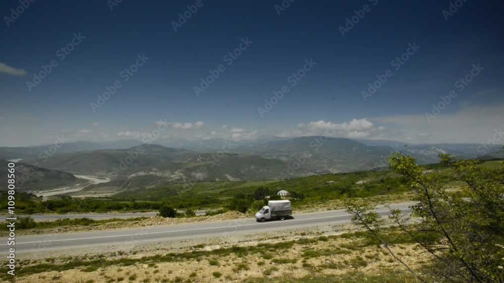 The car goes through the mountains near the forest The car goes through the mountains near the forest