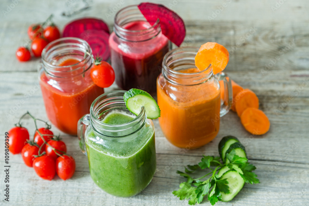 Selection of colorful vegetable juices in glass jars Selection of colorful vegetable juices in glass jars
