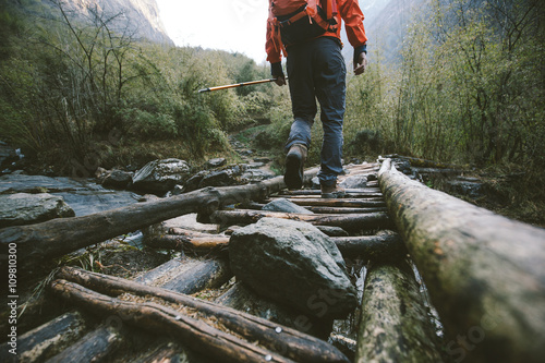 Hiker crossing the bridge in Himalayas
